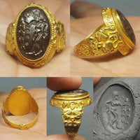 Roman style gold intaglio ring with a large engraved garnet showing woman holding a branch