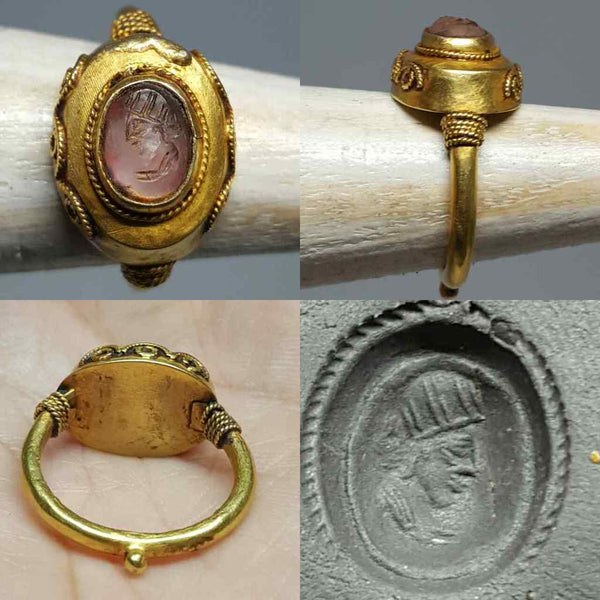 Roman style gold intaglio ring with an engraved amethyst showing a female bust